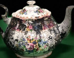 A teapot is decorated in Norwood's curly lines motif. 