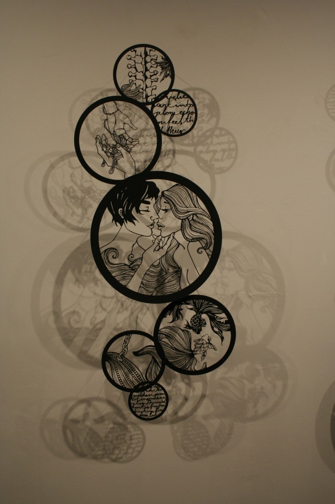 circular laser cut illustrations on a wall