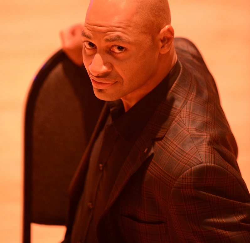 there is a man in a suit and tie sitting at a table