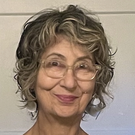there is a woman with glasses smiling for the camera