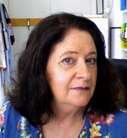 there is a woman sitting at a table with a plate of food