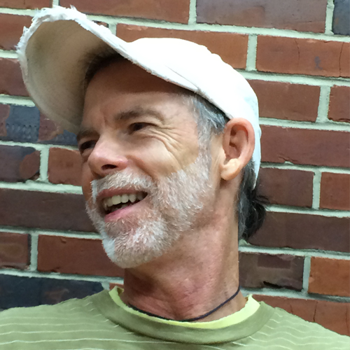 there is a man with a white hat and a green shirt