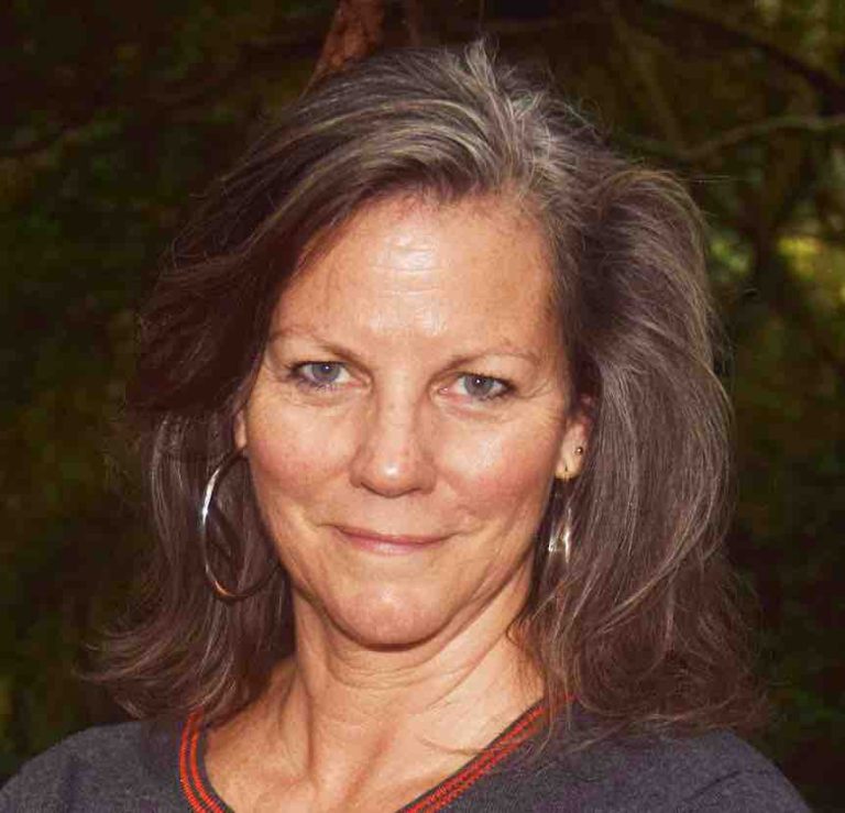 there is a woman that is standing in front of a tree