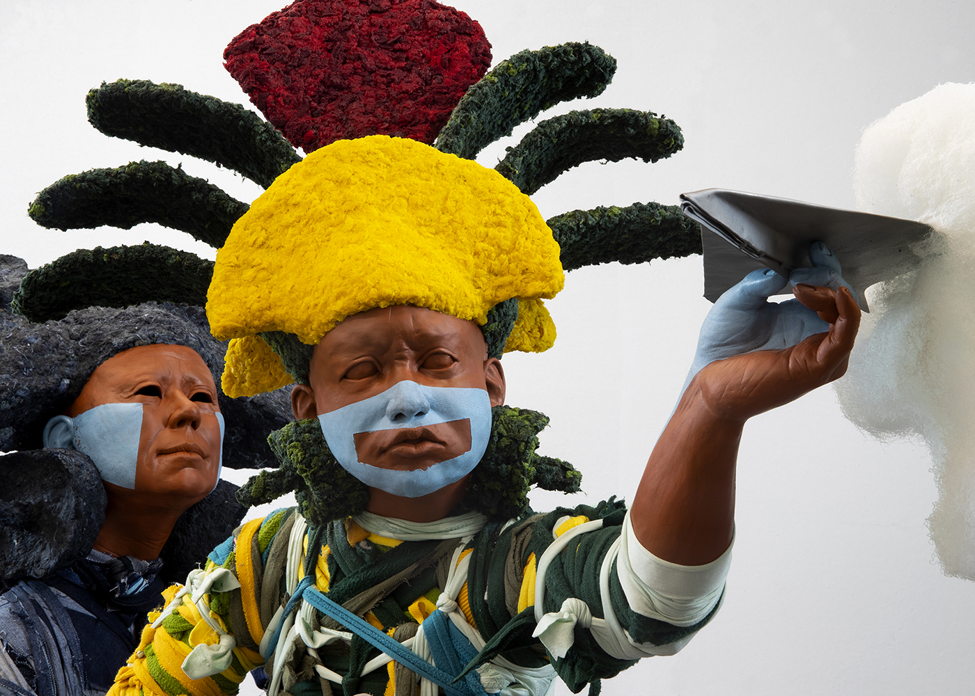there are two people with face paint on their faces and one is holding a pair of scissors