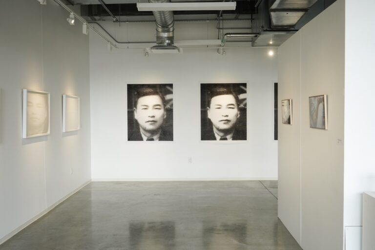there are two black and white pictures on the wall of an art gallery
