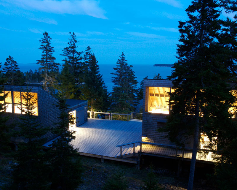 there is a view of a house from the top of a hill at night