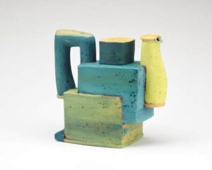 there is a vase and a vase sitting on top of a stack of blocks