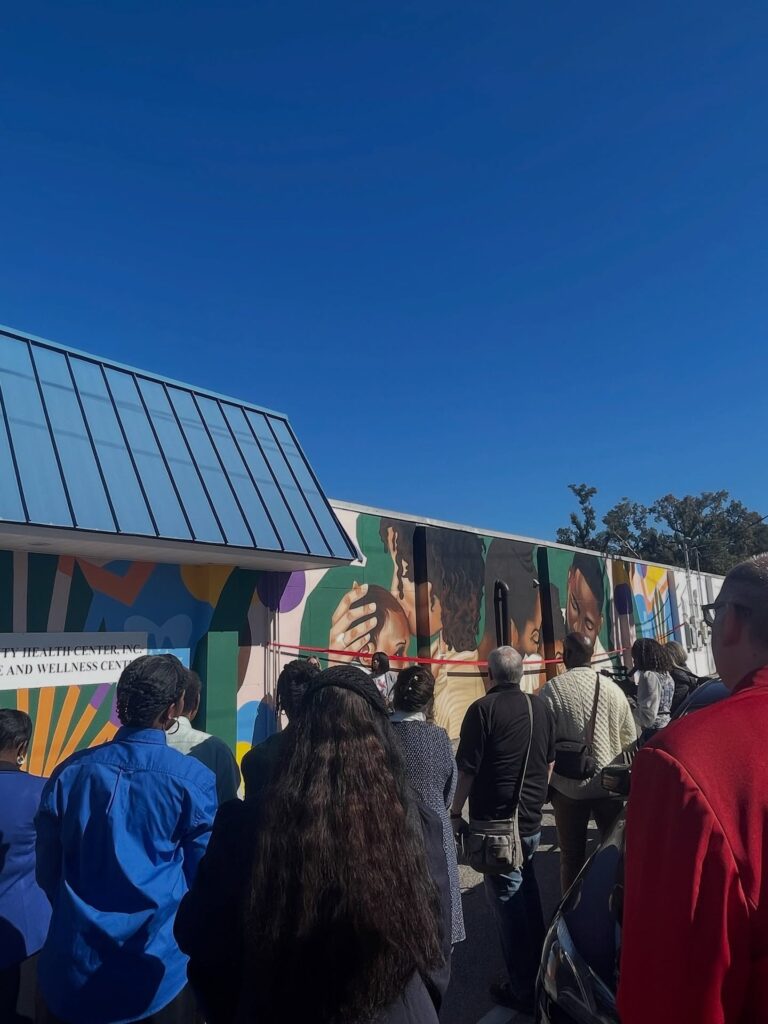 there is a group of people that are standing outside of a train
