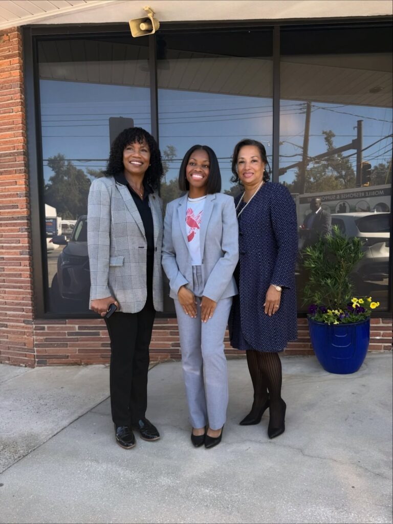 there are three women standing in front of a business building