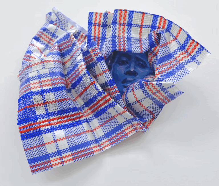 there is a blue and red plaid bow tie with a picture of a man in the center