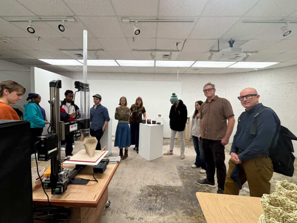 there are many people standing in a room looking at a project