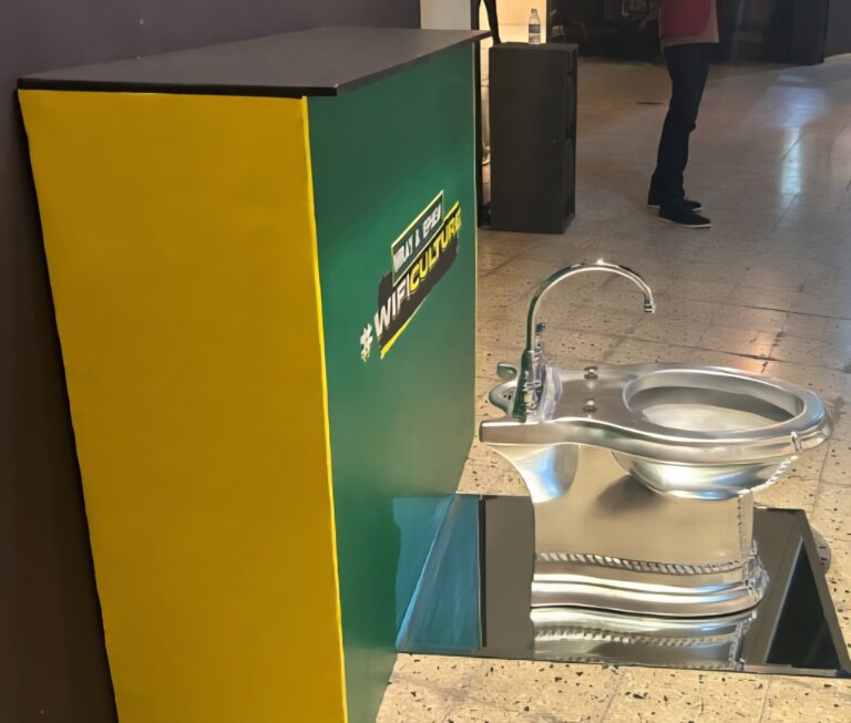 there is a sink that has a metal bowl on top of it