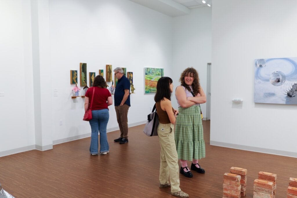 People enjoying art in a gallery. 