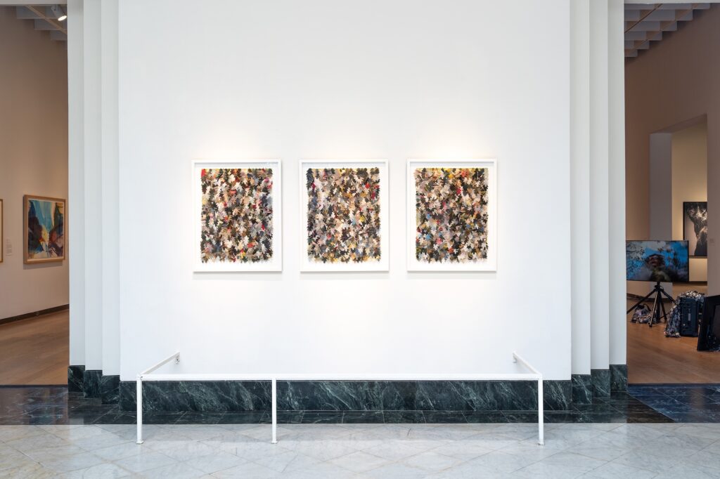 A tryptich of textiles made of leaf shapes.