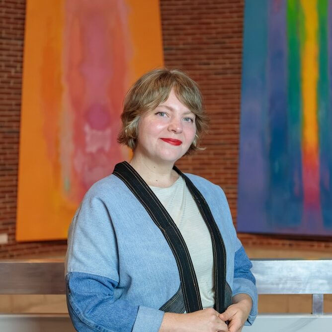 A woman with short blonde hair poses for a photo